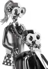 A close-up of two metal figures, one appearing to be a caregiver assisting a person in a wheelchair, both made from nuts, bolts, and other hardware. Voir les images du produit