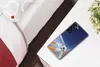 A smartphone case with a soccer illustration is placed on a white table next to a bed. Produktbild-Vorschau