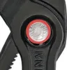 A close-up view of a black adjustable wrench with a red button and silver text. Anteprima dell’immagine prodotto