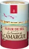 A cylindrical container of Fleur de Sel with a scenic illustration of flamingos flying over a walled city. Voir les images du produit