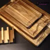 A set of wooden cutting boards stacked on a dark surface. Produktbild-Vorschau