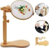 A collage of images showing a wooden embroidery hoop stand with a hoop containing an embroidered floral design, and close-ups of hands using the stand. Produktbild-Vorschau