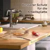 A kitchen counter with a sink, faucet, bread, tomatoes, and a cutting board. Produktbild-Vorschau