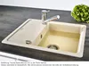 A kitchen sink with a faucet and a head of lettuce in the background. Produktbild-Vorschau