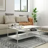 A modern living room scene with a couch, coffee table, and rug. Voir les images du produit