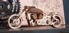A wooden model motorcycle is displayed on a surface with gears and a map in the background. Anteprima dell’immagine prodotto