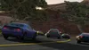 Several cars driving on a winding road in a rural, mountainous area. Produktbild-Vorschau