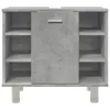 A front view of a concrete-effect bathroom cabinet with open shelves on the sides and a closed cabinet in the middle, resting on white cylindrical legs. Produktbild-Vorschau