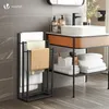 A bathroom scene with a towel rack and sink. Produktbild-Vorschau