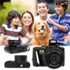 A family and their dog are posing for a photo, with a digital camera prominently displayed in the foreground. Produktbild-Vorschau