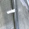 A close-up view of a white fabric with a grid pattern, attached to a metal frame. A white fabric tab is visible, securing the fabric to the frame. Produktbild-Vorschau