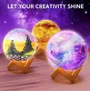 Three decorative lamps shaped like celestial bodies, each on a wooden stand, against a starry purple background. Produktbild-Vorschau
