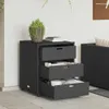 A black poly rattan storage cabinet with three drawers is shown outdoors on a tiled patio. Anteprima dell’immagine prodotto
