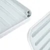 Close-up view of two light gray dish drying mats with ribbed surfaces and curved edges. Podgląd zdjęcia produktu