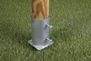 A metal post anchor is screwed into a wooden post, which is placed on artificial grass. Produktbild-Vorschau