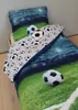 A soccer-themed bedding set is displayed on a bed, with a pillow and duvet cover featuring stadium and soccer ball graphics. A soccer ball is placed on the duvet. Náhľad obrázku produktu