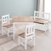 A children's table and chairs set with a storage bench, set against a light blue wall and light wood floor. Produktbild-Vorschau