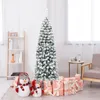 A decorated artificial Christmas tree with snow, surrounded by gifts and two snowman figures, in a room with a shelf and a chair. Podgląd zdjęcia produktu
