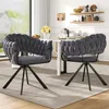 Two gray velvet dining chairs with braided backs are placed around a white dining table in a well-lit room. Voir les images du produit