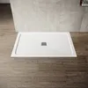 A white shower tray with a drain is placed on a wooden floor, with tiled walls in the background. Anteprima dell’immagine prodotto