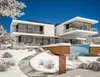 A modern white house with a swimming pool in a snowy landscape. Produktbild-Vorschau