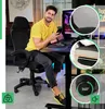 A man is sitting in a gaming chair at a desk with a computer. Produktbild-Vorschau