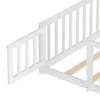 A close-up view of a white wooden bed frame with a guardrail. Podgląd zdjęcia produktu