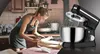 A woman is shown in a kitchen preparing dough, with a stand mixer prominently displayed on the right side of the image. Produktbild-Vorschau
