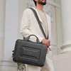A man in a suit walks with a laptop bag. Náhled obrázku produktu