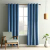 A living room scene with blue curtains, a chair, and a plant. Produktbild-Vorschau