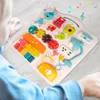 A child's hands interacting with a colorful educational toy table. Podgląd zdjęcia produktu