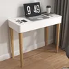 A white desk with wooden legs, featuring a laptop, glasses, and a coffee cup. Produktbild-Vorschau