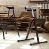 Two black metal roller stands supporting wooden planks in a workshop setting. Produktbild-Vorschau