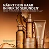 A collection of Wella hair care products displayed against a backdrop of flowing golden liquid. Produktbild-Vorschau