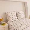 A close-up view of a bed with floral patterned bedding. Produktbild-Vorschau