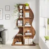 A wooden bookshelf filled with decorative items and plants, placed next to a sofa in a living room. Produktbild-Vorschau