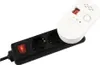 A white gas alarm device is plugged into a black power strip with a red switch. Náhľad obrázku produktu