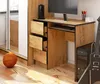 A desk with a computer, keyboard, and accessories in a room setting. Produktbild-Vorschau