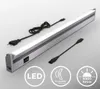A linear LED light fixture with attached power cord and an additional connector cable, presented on a light gray background with informational icons. Náhľad obrázku produktu