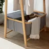 A close-up of a bamboo clothing rack with fabric storage bins. Anteprima dell’immagine prodotto