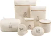 A collection of seven beige mesh laundry bags with zippers and embroidered clothing icons, arranged on a white background. Produktbild-Vorschau