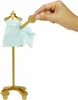 A hand is holding a gold accessory over a gold mannequin with a light blue fabric draped over it. Produktbild-Vorschau