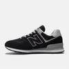 A side view of a black and gray New Balance sneaker against a white background. Voir les images du produit