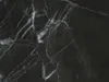 A close-up, textured view of black marble with white veining. Produktbild-Vorschau