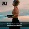 A woman is holding a black Bluetooth speaker outdoors with a cloudy sky in the background. Voir les images du produit