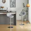 Two gray bar stools are placed next to a bar counter in a room with a floor lamp and a plant. Anteprima dell’immagine prodotto