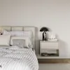 A bedroom scene with a bed and a nightstand. Voir les images du produit