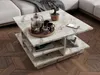 A marble coffee table with books and decorative items on it, placed on a wooden floor next to a sofa. Náhľad obrázku produktu