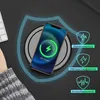 A smartphone is being wirelessly charged on a black charging pad, with a keyboard visible in the background. Protective shield icons with German text are displayed on the right side. Produktbild-Vorschau