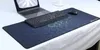 A gaming mousepad with a hexagonal pattern and a laptop, keyboard, and mouse on top. Náhled obrázku produktu